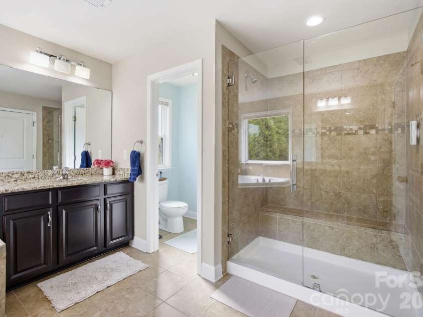 7223 Old Valley Way, Harrisburg, NC 28075.  MLS# CAR4378364, YatesRealty ID 19342. Primary Bath frameless shower door