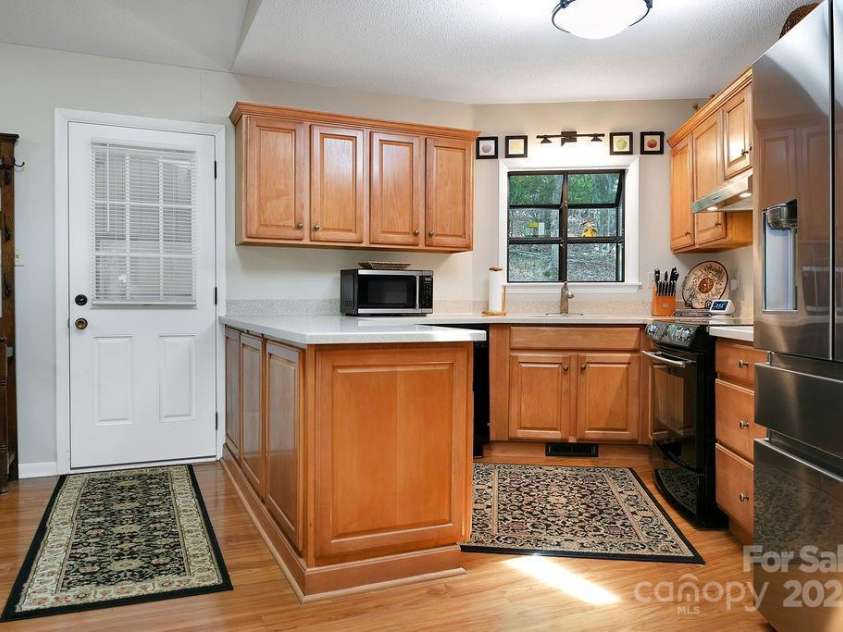 1005 Middle Connestee Trail, Brevard, NC 28712.  MLS# CAR4269691, YatesRealty ID 19349. Cabinets boast pull outs for easy storage