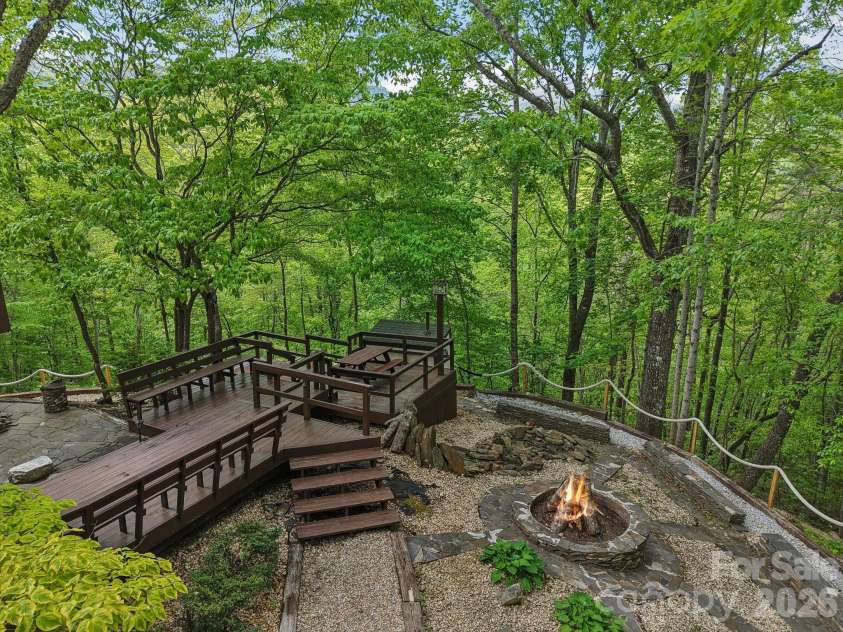 295 Dills Road, Bryson City, NC 28713.  MLS# CAR4373473, YatesRealty ID 19361. Overlooking the multi-level terraced space with walkways, sitting areas and a firepit