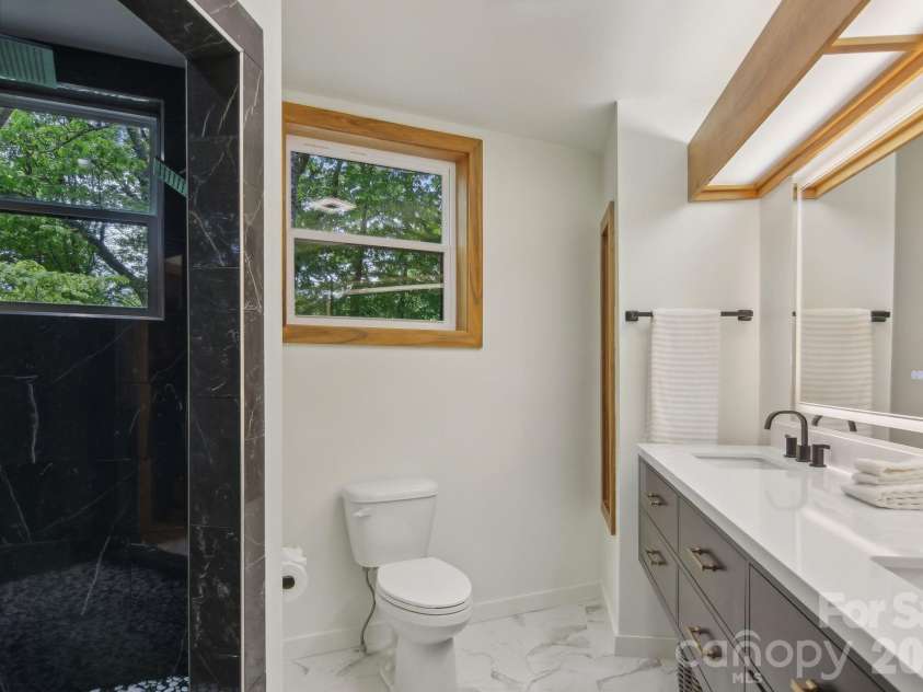 295 Dills Road, Bryson City, NC 28713.  MLS# CAR4373473, YatesRealty ID 19361. Renovated and updated ensuite bath on lower level