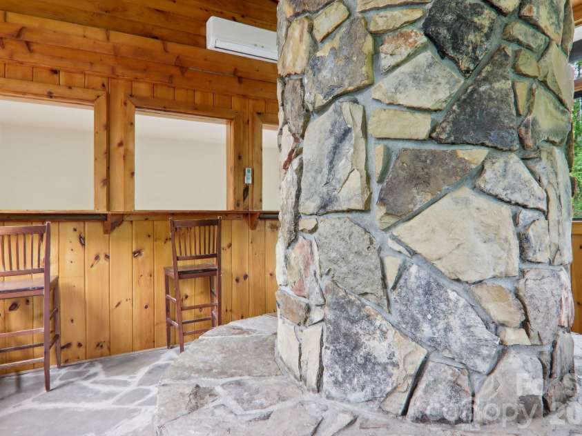 295 Dills Road, Bryson City, NC 28713.  MLS# CAR4373473, YatesRealty ID 19361. The lower level anchored by the multi-level stone fireplace