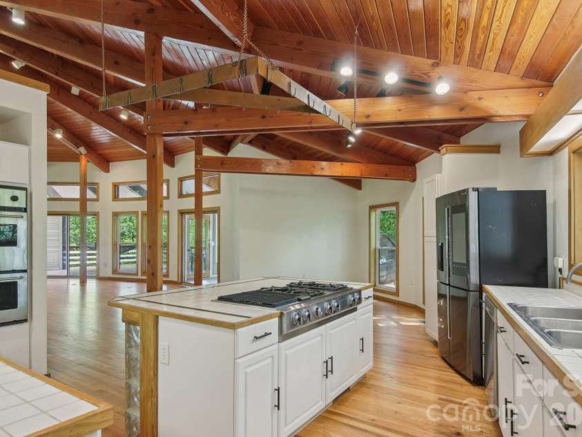 295 Dills Road, Bryson City, NC 28713.  MLS# CAR4373473, YatesRealty ID 19361. The open concept kitchen into the living and dining areas