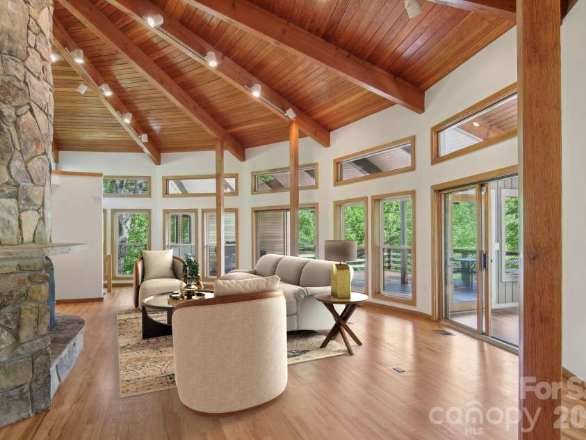 295 Dills Road, Bryson City, NC 28713.  MLS# CAR4373473, YatesRealty ID 19361. Virtually staged living area with stone hearth and fireplace