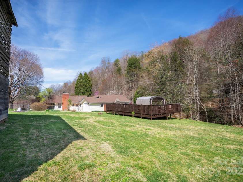492 Paint Fork Road, Barnardsville, NC 28709.  MLS# CAR4239346, YatesRealty ID 19369. View from barn towards house and pool deck