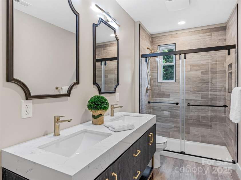 162 Courtland Place, Asheville, NC 28801.  MLS# CAR4261167, YatesRealty ID 19387. Bathroom with double vanity and walk in shower