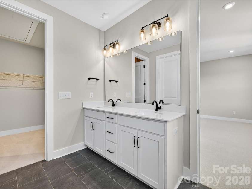 325 Ardmore Drive, Belmont, NC 28012.  MLS# CAR4378189, YatesRealty ID 19425. Dual vanity primary bathroom with a walk-in closet 