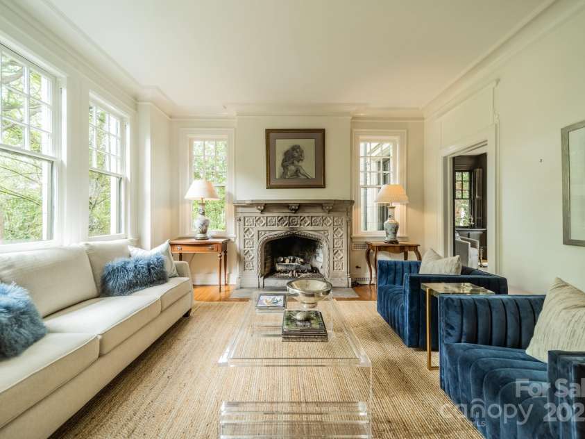 1919 Kensal Court, Charlotte, NC 28211.  MLS# CAR4193792, YatesRealty ID 19433. Cozy up by the gas fire or watch the birds from the many windows in the Living Room.  The doorway on the right leads to a downstairs bedroom that could make a great office/study/lounge!