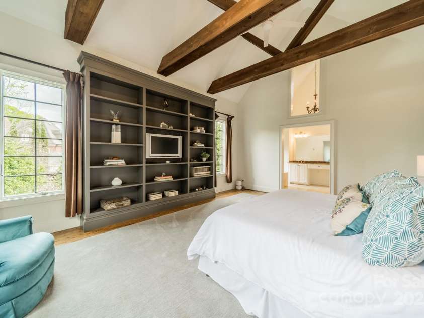 1919 Kensal Court, Charlotte, NC 28211.  MLS# CAR4193792, YatesRealty ID 19433. Primary Bedroom with built-ins and a view of the bathroom.