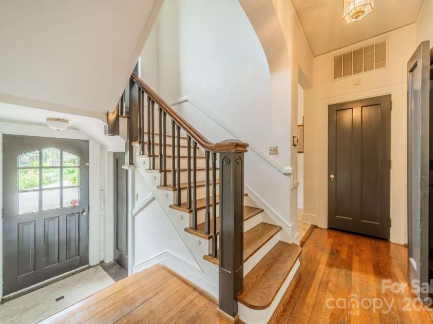 1919 Kensal Court, Charlotte, NC 28211.  MLS# CAR4193792, YatesRealty ID 19433. Stairs going up lead to the Primary Suite and 4 additional bedrooms plus a 3rd floor bonus room.  The stairs going down lead to the interior basement and to the backyard.