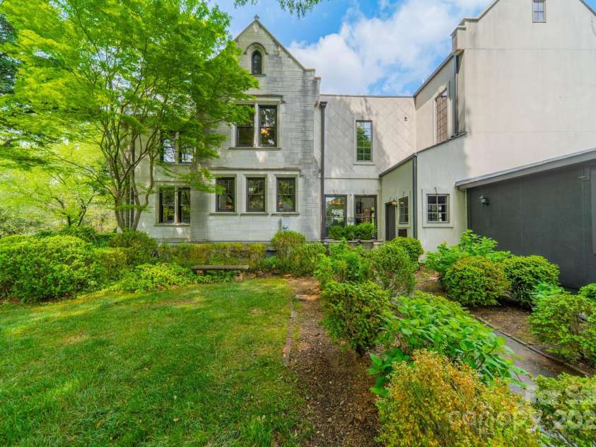 1919 Kensal Court, Charlotte, NC 28211.  MLS# CAR4193792, YatesRealty ID 19433. Walkway from the driveway and extra parking.  The 3 car garage is on the right.