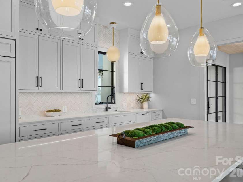 17811 Largo Place, Cornelius, NC 28031.  MLS# CAR4428601, YatesRealty ID 1945. Designer kitchen with statement island, custom cabinetry, Wolf appliances and curated finishes.