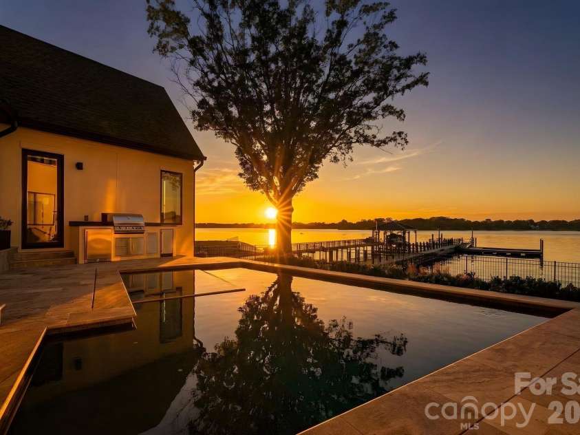 17811 Largo Place, Cornelius, NC 28031.  MLS# CAR4428601, YatesRealty ID 1945. Golden-hour living at its finest, where the pool, spa and waterfront converge against a backdrop of sweeping Lake Norman sunsets.