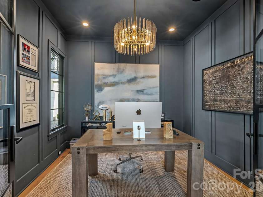 17811 Largo Place, Cornelius, NC 28031.  MLS# CAR4428601, YatesRealty ID 1945. Moody, sophisticated study defined by custom wall paneling, glass doors and sculptural statement lighting.