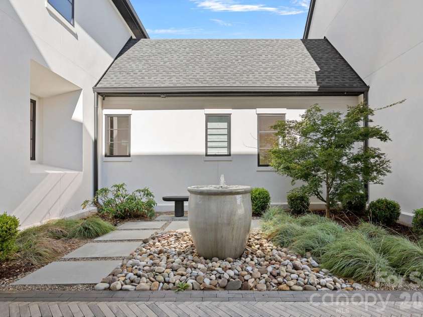 17811 Largo Place, Cornelius, NC 28031.  MLS# CAR4428601, YatesRealty ID 1945. Tranquil garden courtyard with sculptural fountain and thoughtfully curated landscaping.