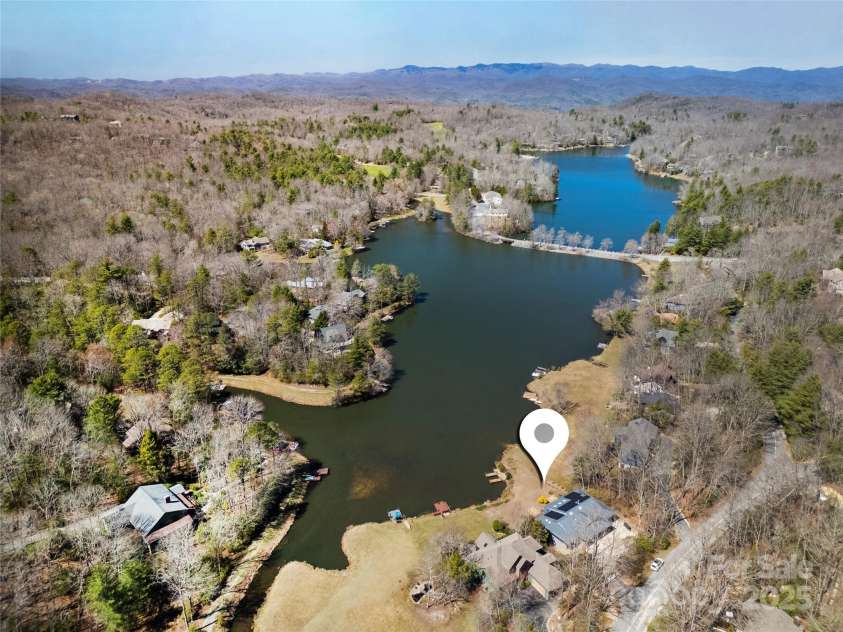 61 Tsataga Court, Brevard, NC 28712.  MLS# CAR4250347, YatesRealty ID 19462. Nestled on the serene stretch of Lake Atagahi lovingly known as 'Little Atagahi,' this home offers a peaceful lakeside retreat cherished by the community for its quiet, tranquil atmosphere.