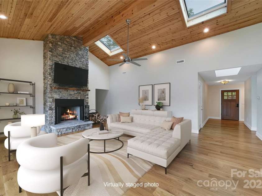 61 Tsataga Court, Brevard, NC 28712.  MLS# CAR4250347, YatesRealty ID 19462. Nothing beats a cozy stacked-stone fireplace on a chilly winter night. Kick back, relax, and enjoy the warmth and vibe it’s the perfect spot to unwind.