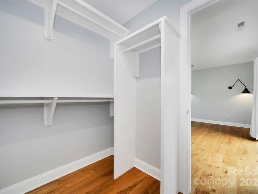 61 Tsataga Court, Brevard, NC 28712.  MLS# CAR4250347, YatesRealty ID 19462. The primary suite features a spacious walk-in closet.