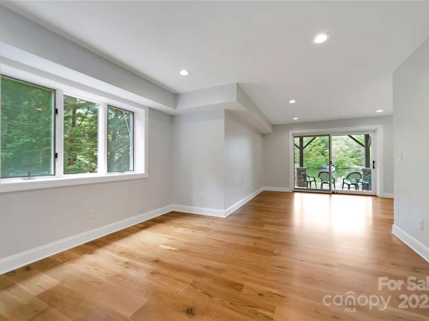 61 Tsataga Court, Brevard, NC 28712.  MLS# CAR4250347, YatesRealty ID 19462. This downstairs area is a blank slate, ready to be customized to your lifestyle. The current owner has utilized it as an additional office and exercise space, but the possibilities are endless whether you envision a home th