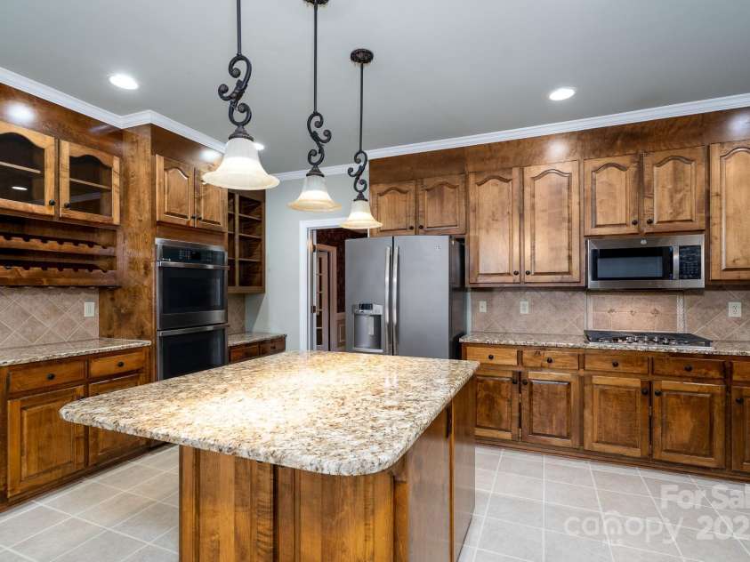 4672 Snow Drive, Harrisburg, NC 28075.  MLS# CAR4268077, YatesRealty ID 19470. Don't forge the built in wine rack and desk area.