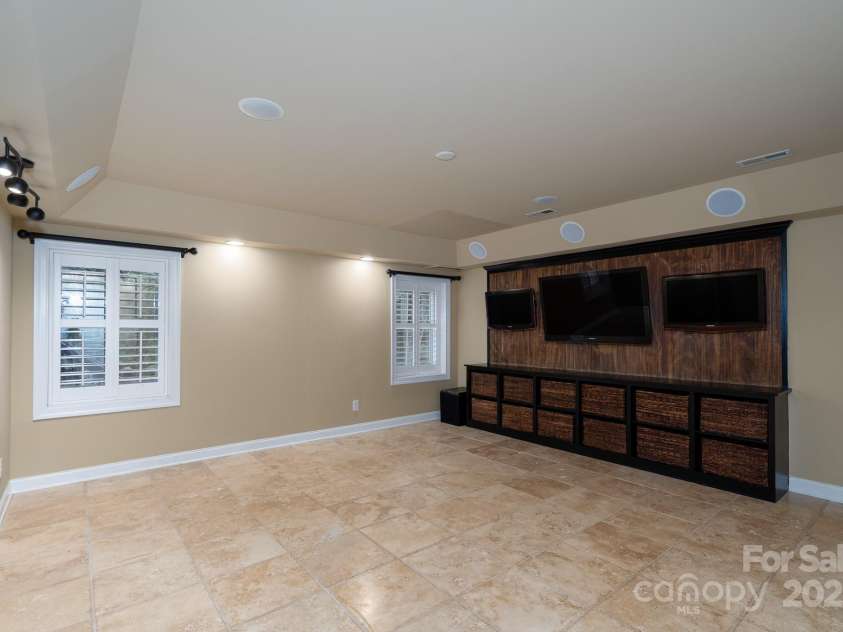4672 Snow Drive, Harrisburg, NC 28075.  MLS# CAR4268077, YatesRealty ID 19470. Entertaining area/ living room in finished basement.
