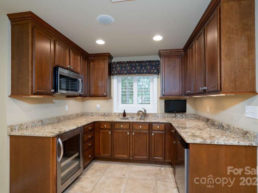 4672 Snow Drive, Harrisburg, NC 28075.  MLS# CAR4268077, YatesRealty ID 19470. Fully finished basement kitchen area.