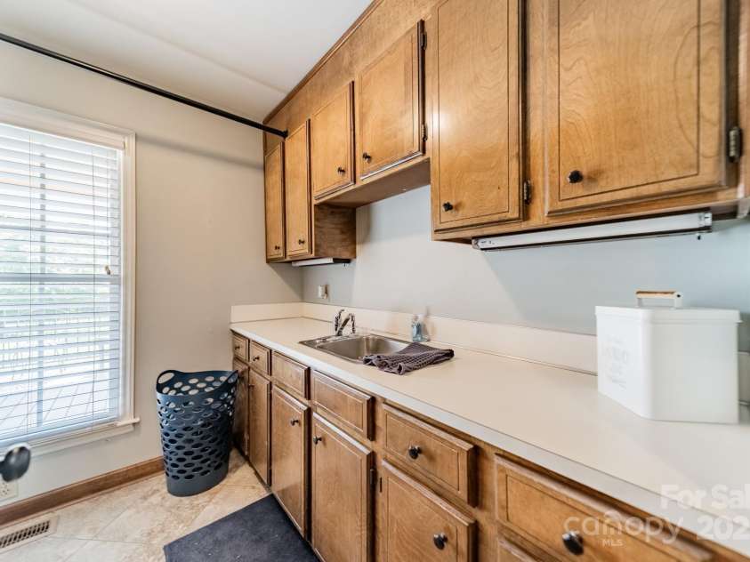 8698 Rocky River Road, Harrisburg, NC 28075.  MLS# CAR4263046, YatesRealty ID 19472. Laundry Room