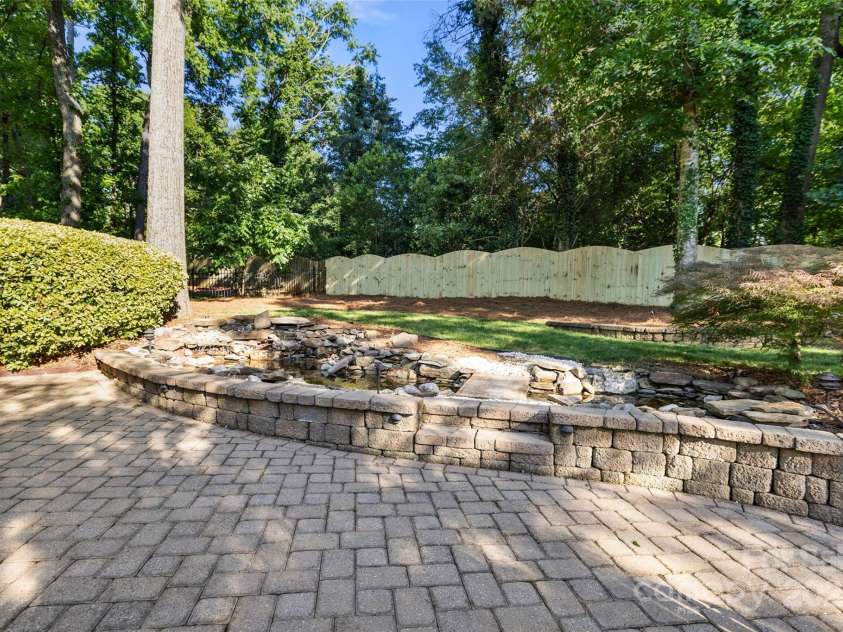 9219 Whispering Wind Drive, Charlotte, NC 28277.  MLS# CAR4261114, YatesRealty ID 19480. Koi pond that has waterfall feature!