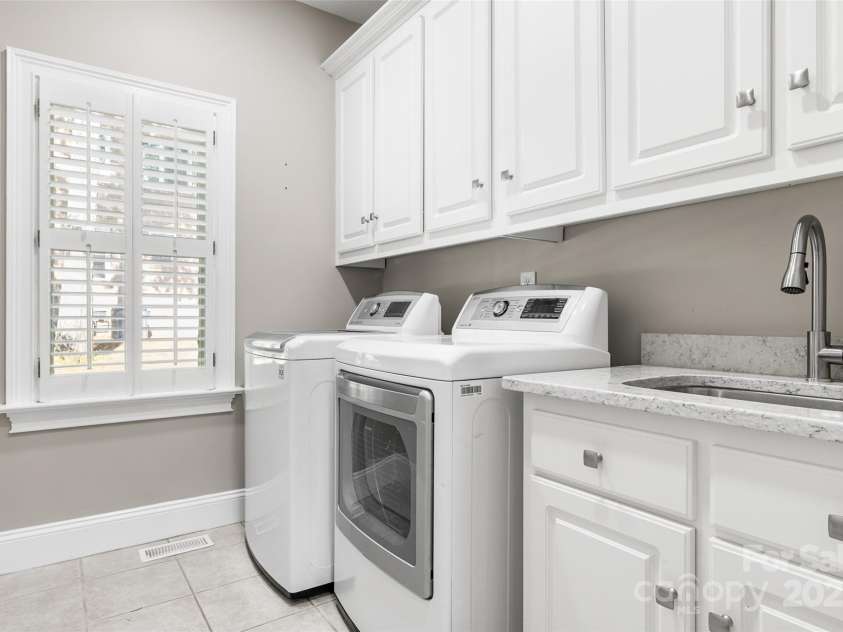9219 Whispering Wind Drive, Charlotte, NC 28277.  MLS# CAR4261114, YatesRealty ID 19480. Laundry room with cabinets and sink with vanity!