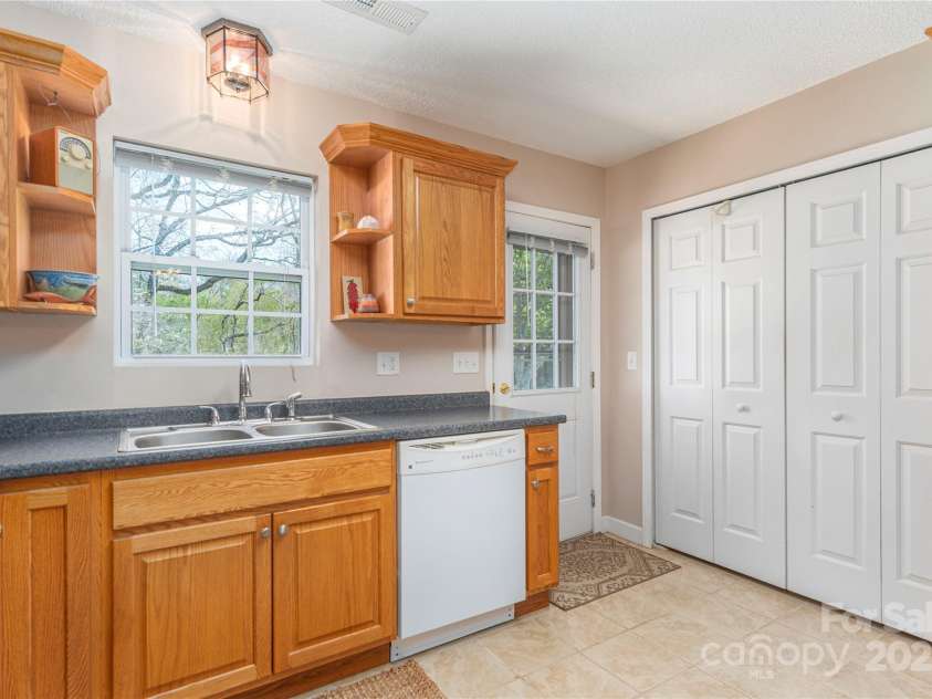 104 Kerlee Street, Black Mountain, NC 28711.  MLS# CAR4245652, YatesRealty ID 19482. Kitchen - Laundry behind folding doors