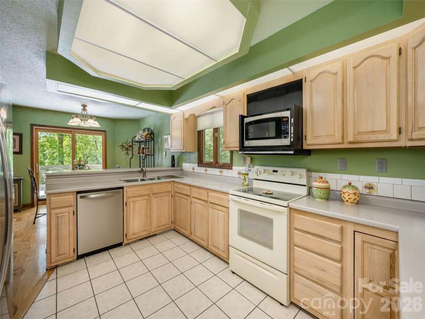 142 Sequoyah Hills Drive, Fletcher, NC 28732.  MLS# CAR4372471, YatesRealty ID 19496. Kitchen is large enough for 2 cooks