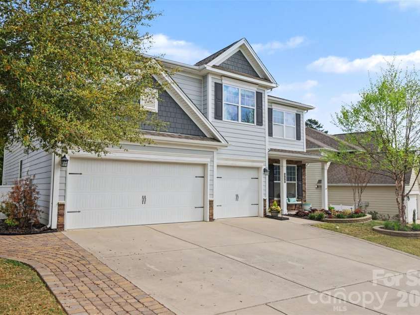 850 Coralbell Way, Fort Mill, SC 29708.  MLS# CAR4365980, YatesRealty ID 19501. 3-car garage and extended driveway with paver path to the fenced backyard. 
