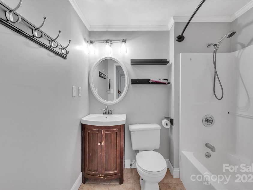 450 Lemmons Road, Mooresboro, NC 28114.  MLS# CAR4248838, YatesRealty ID 19504. Full downstairs back with distressed looking vanity and hand held shower