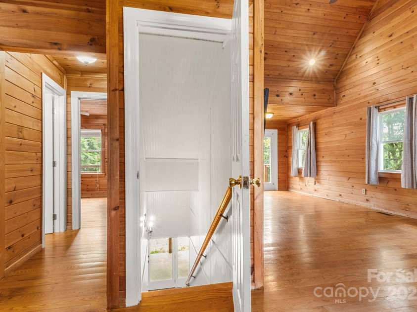 450 Lemmons Road, Mooresboro, NC 28114.  MLS# CAR4248838, YatesRealty ID 19504. Wooden stairs to walk out level and bedroom and bath to left