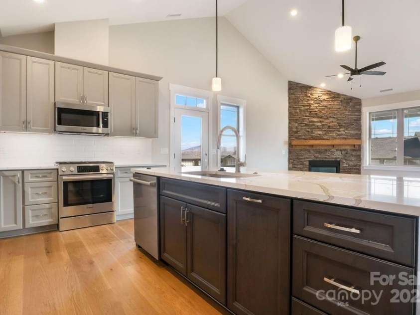 175 Waightstill Drive, Arden, NC 28704.  MLS# CAR3874338, YatesRealty ID 19507. Kitchen with Island overlooking Living Room