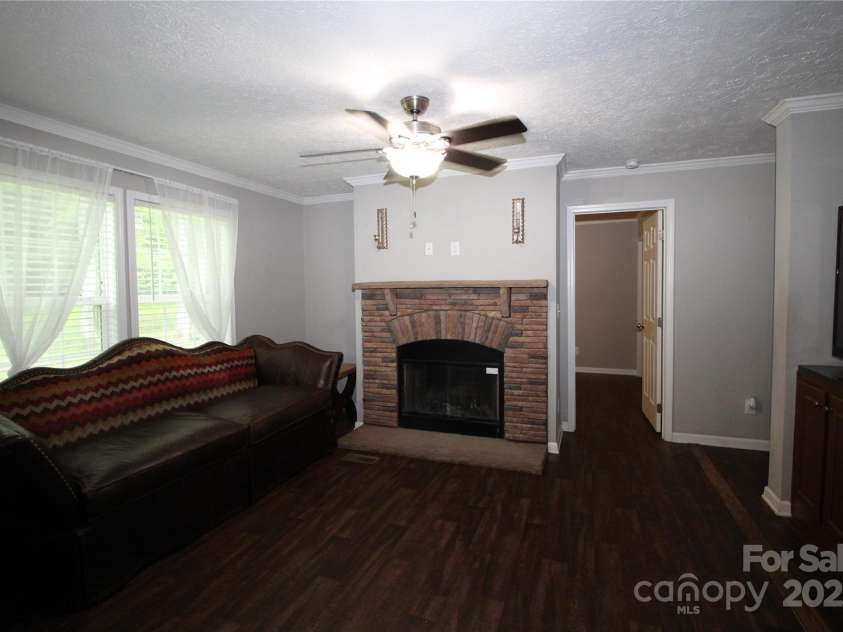 2310 Alfred Hartley Road, Lenoir, NC 28645.  MLS# CAR4258802, YatesRealty ID 19511. Den with a woodburning fireplace.