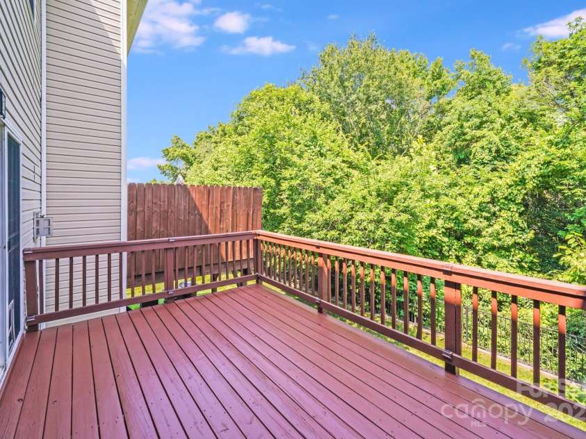 9800 Walkers Glen Drive, Concord, NC 28027.  MLS# CAR4265265, YatesRealty ID 19543. BEAUTIFULPRIVATE  DECK OFF LIVING AREA WITH GREEN SPACE BEHIND
