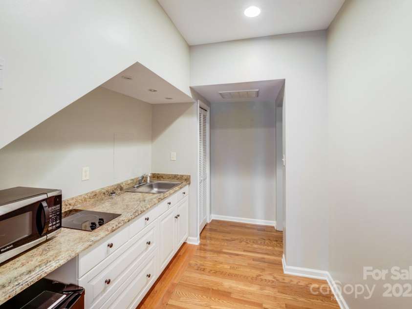 9800 Walkers Glen Drive, Concord, NC 28027.  MLS# CAR4265265, YatesRealty ID 19543. KITCHENETTE GOING TOWARDS 1ST FLOOR BEDROOM