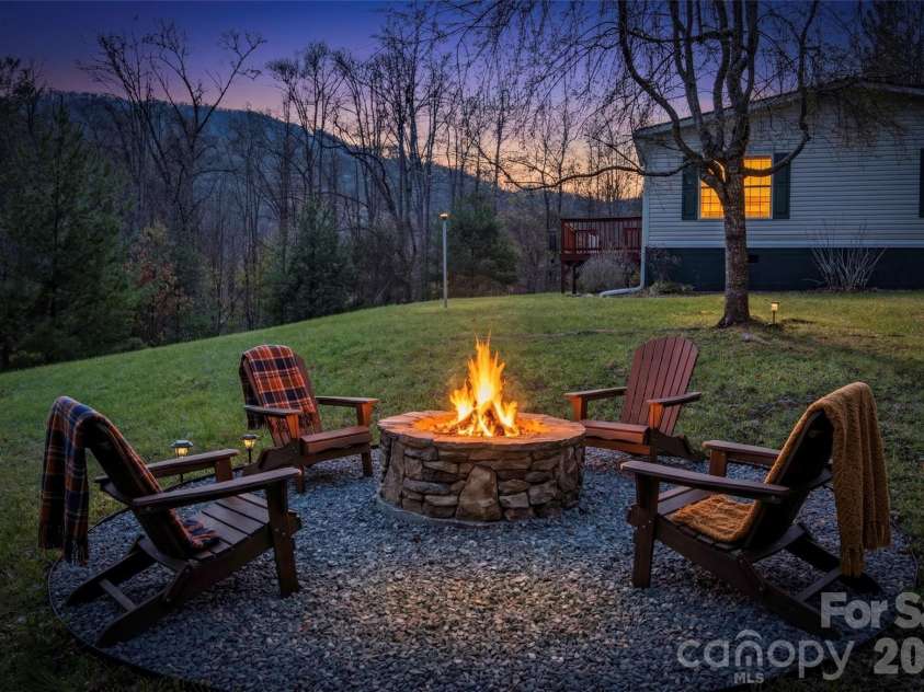155 Thunderstruck Ridge, Burnsville, NC 28714.  MLS# CAR4365534, YatesRealty ID 19561. Side yard fire pit (Staged)