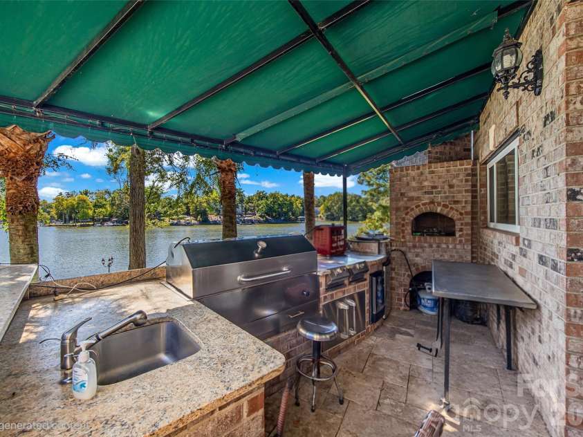 5650 Riverfront Road, Clover, SC 29710.  MLS# CAR4310458, YatesRealty ID 19574. Wing - Outdoor kitchen w/pizza oven