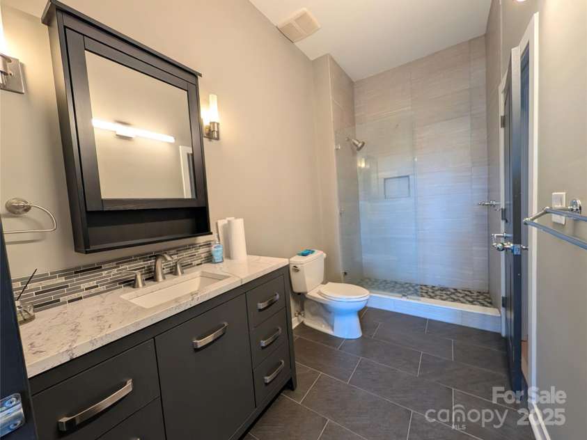 360 Exchange Street, Concord, NC 28027.  MLS# CAR4321208, YatesRealty ID 1959. Beautiful updated bath with a designer feel!  Such a nice look with the wonderful tile and granite.