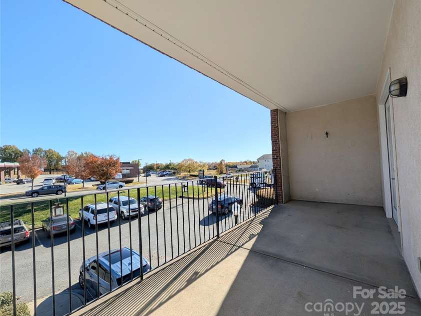 360 Exchange Street, Concord, NC 28027.  MLS# CAR4321208, YatesRealty ID 1959. The primary living space and the primary bedroom open to this spacious patio.