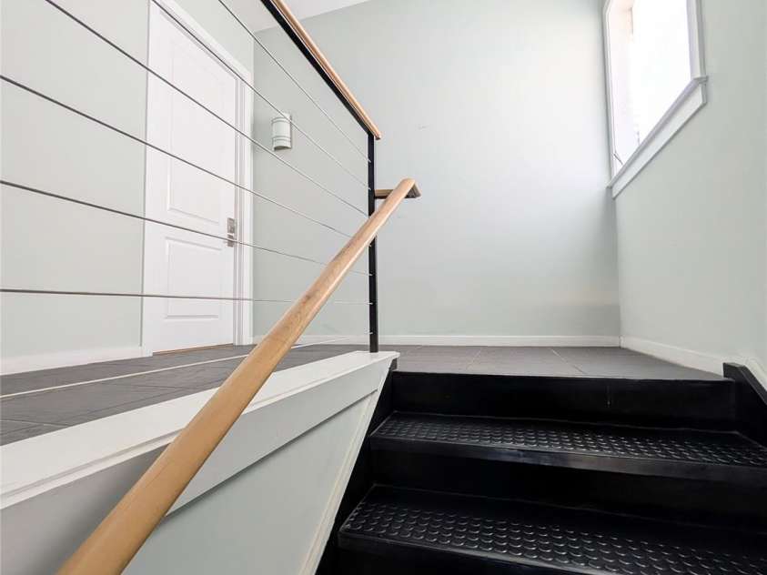 360 Exchange Street, Concord, NC 28027.  MLS# CAR4321208, YatesRealty ID 1959. Well appointed stairwell with lots of light - this stairwell is the entrance for this unit and one other.