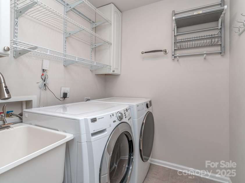 12214 Ardrey Park Drive, Charlotte, NC 28277.  MLS# CAR4247491, YatesRealty ID 19591. 3rd floor laundry room with sink & cabinets.