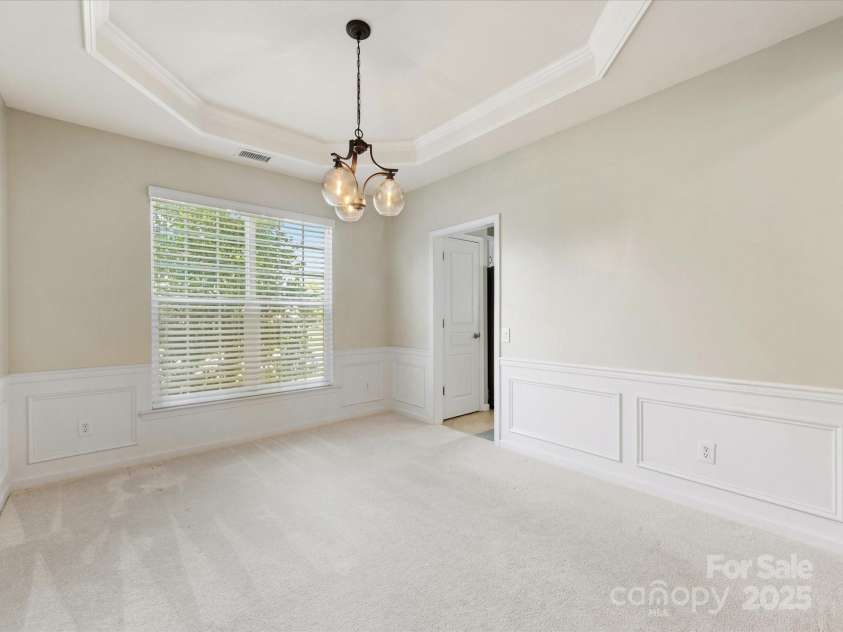 8603 Robinson Meadow Court, Charlotte, NC 28277.  MLS# CAR4265734, YatesRealty ID 19593. The dining room features a tray ceiling and wainscoting.