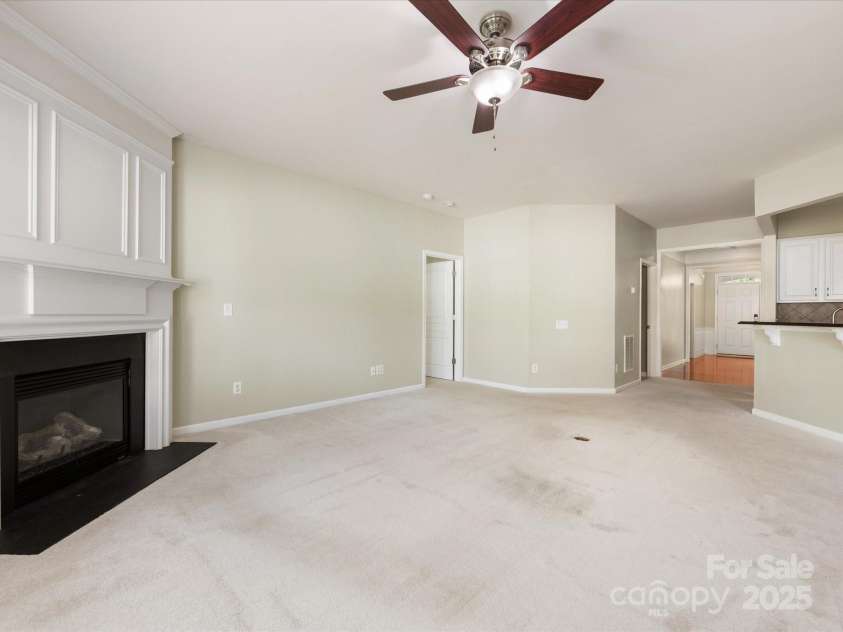 8603 Robinson Meadow Court, Charlotte, NC 28277.  MLS# CAR4265734, YatesRealty ID 19593. The family room features a gas log fireplace and a ceiling fan.