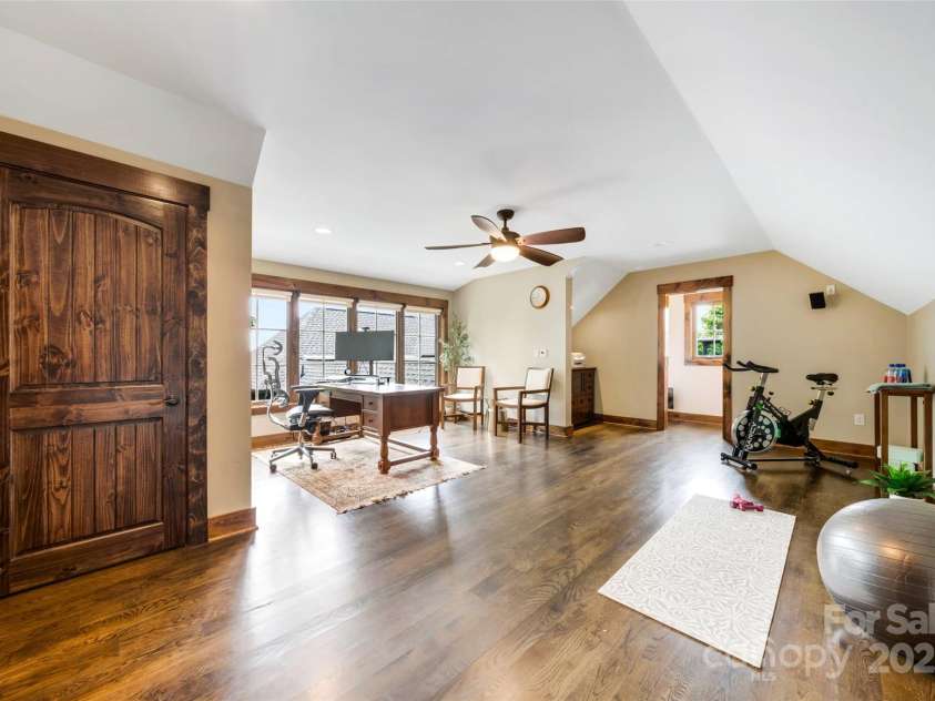 84 Meadow Top Lane, Hendersonville, NC 28792.  MLS# CAR4290136, YatesRealty ID 19615. Home office or creative studio space located above the garage (434sf). Connects to the main house via covered breezeway.