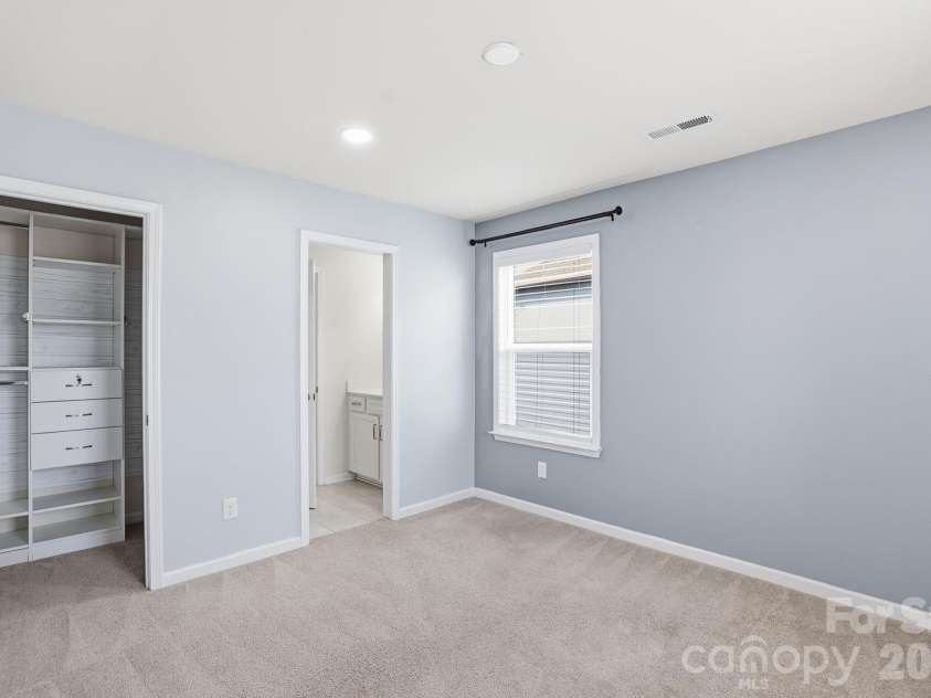 4029 Spring Garden Street, Fort Mill, SC 29715.  MLS# CAR4354877, YatesRealty ID 19618. Main level bedroom with private bath and exit outside on side door. 