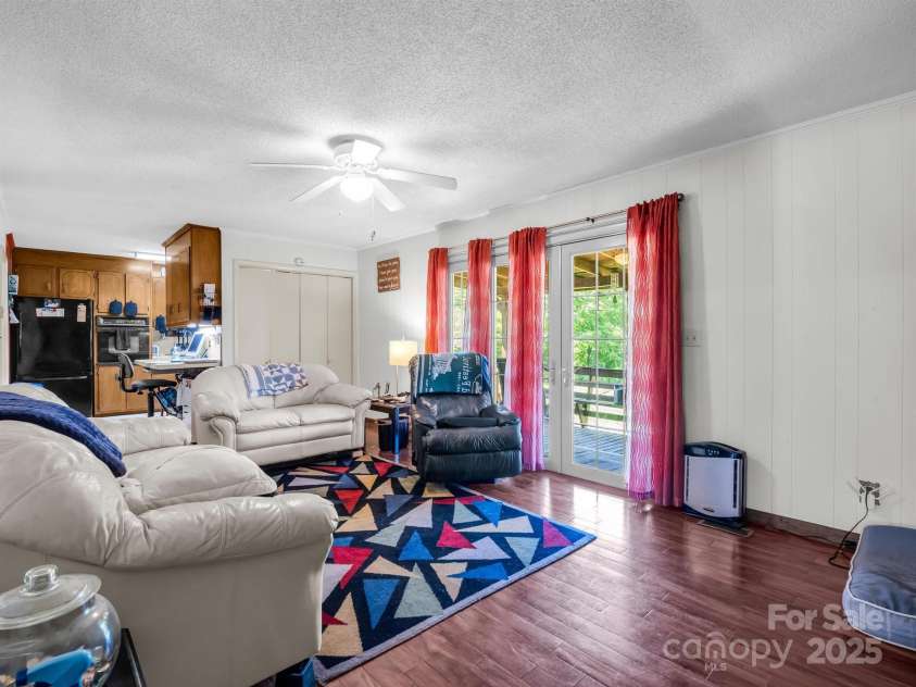 2512 Brevard Road, Hendersonville, NC 28791.  MLS# CAR4237635, YatesRealty ID 19632. Family room with hardwood floors