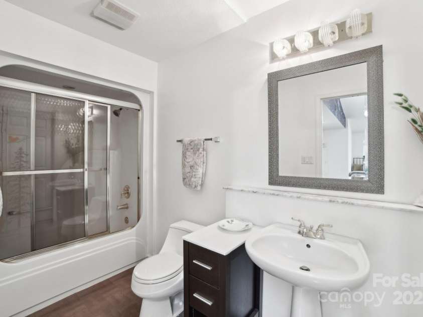 142 Justice Street, Fletcher, NC 28732.  MLS# CAR4234693, YatesRealty ID 19634. A sleek and modern bathroom with sophisticated finishes and design