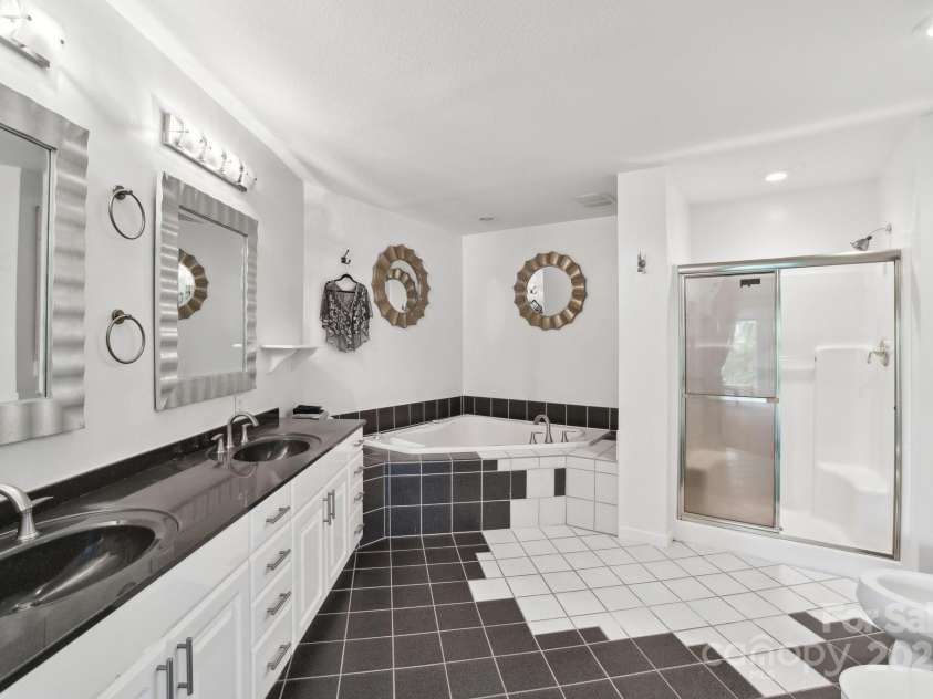 142 Justice Street, Fletcher, NC 28732.  MLS# CAR4234693, YatesRealty ID 19634. Luxurious primary bathroom with dual vanities
